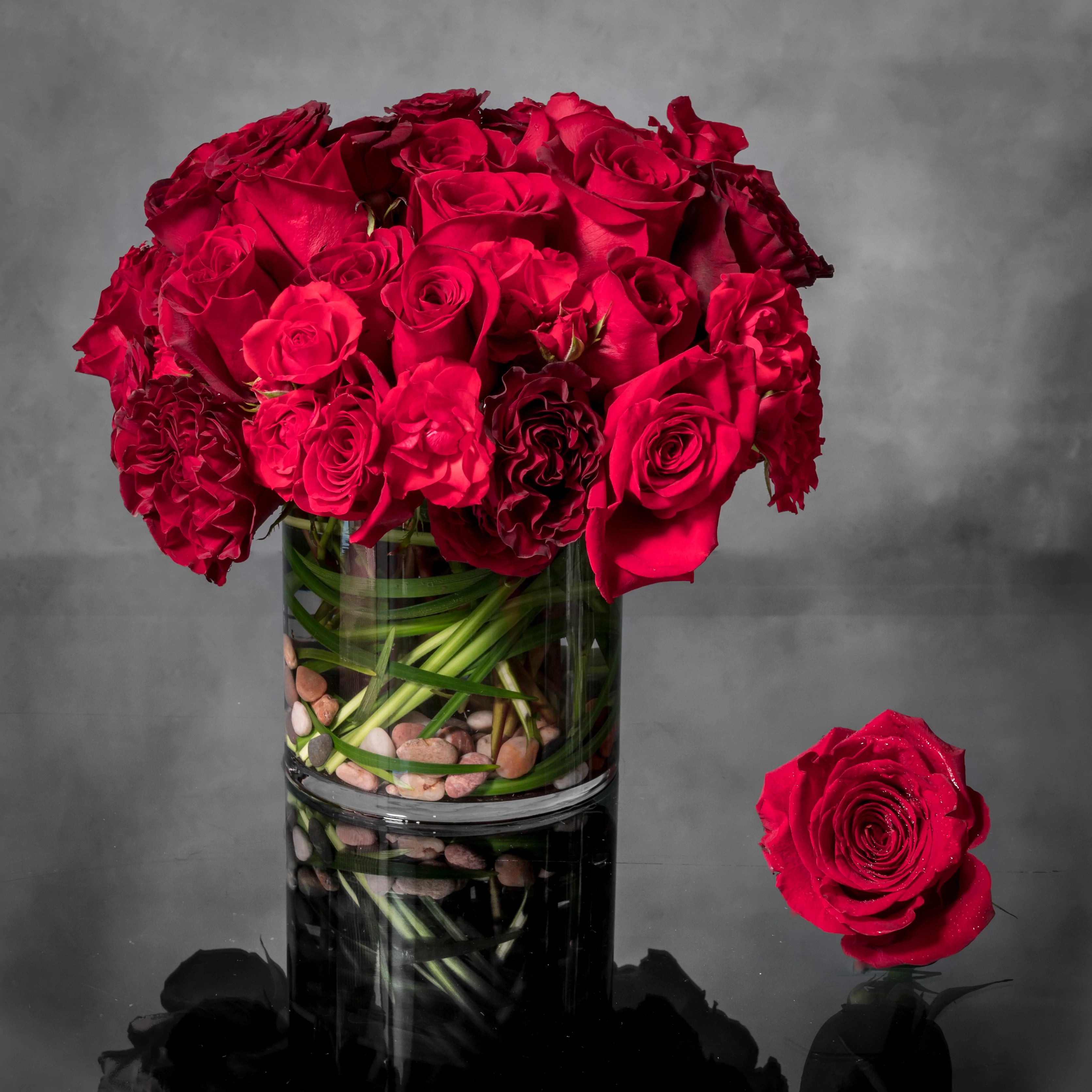 20210814-_DSC0037-1 Beverly Hills Florist presents Crimson Reds for same day delivery! Includes Red Roses, Seasonal Greens and are accented with stones in a glass vase. Perfect for Love and Romance, Birthdays, Holiday and more!
