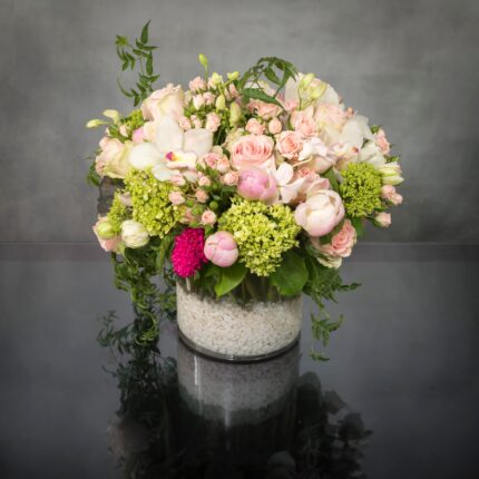 Same day delivery at Beverly Hills Florist ! Breathtaking medley of beautiful pink Ecuadorian roses and spray roses, peonies, cymbidium orchids, lime green accents and other seasonal floral that are artistically arranged to create this stunning design in a white rocks glass vase. The pink-white lime is a delightful combination to express happiness!