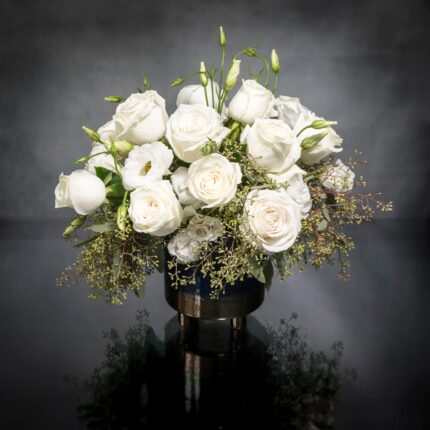 Beverly Hills Florist presents this is a beautiful marriage of two varieties of flowers for same day delivery ... Lisianthus  and Roses nested on seasonal greens in a blue and gold footed vase. Birthday flowers, Thank you flowers, Thinking of you flowers and get well soon flowers.