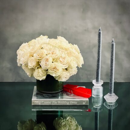 Beverly Hills Florist presents this simplicity, pure, and elegant white roses in a classic 5x5 glass vase. Specialty premium white Ecuadorian roses are clustered in a fresh, full and delicate arrangement. Offering same day delivery for our wonderful roses in white. Marvelously made for love and romance, anniversary, thinking of you, get well soon, welcome and thank you !