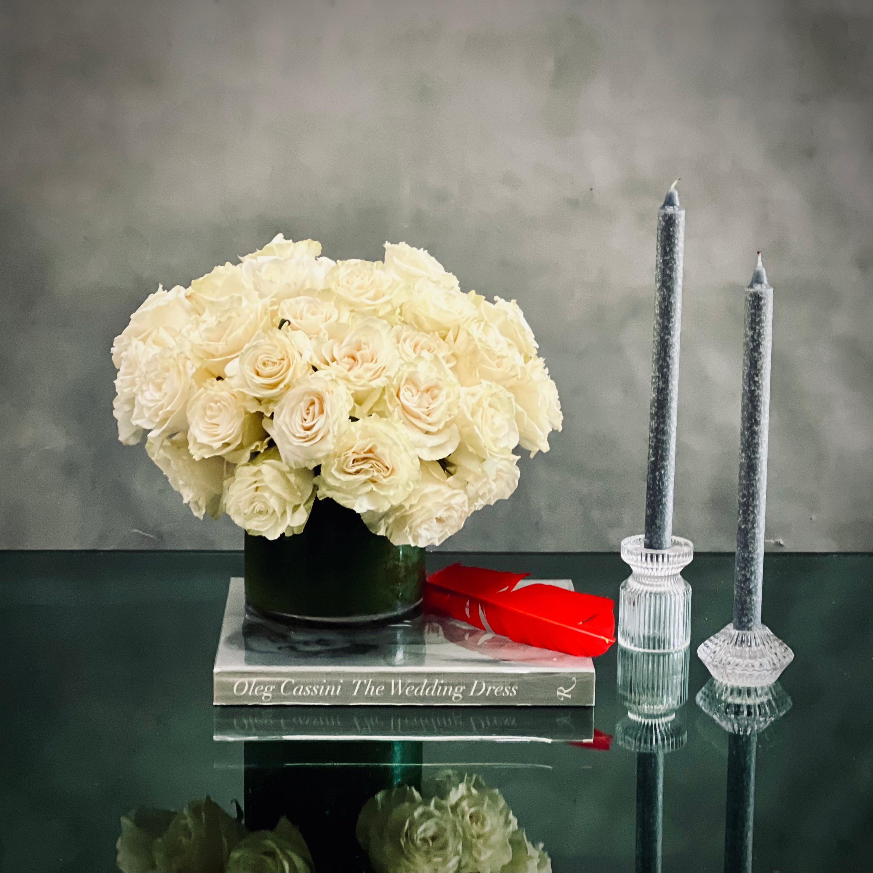 50_white_roses_90dbb705-fc49-4d51-b81a-b6ecba1dbd0b Beverly Hills Florist presents this simplicity, pure, and elegant white roses in a classic 5x5 glass vase. Specialty premium white Ecuadorian roses are clustered in a fresh, full and delicate arrangement. Offering same day delivery for our wonderful roses in white. Marvelously made for love and romance, anniversary, thinking of you, get well soon, welcome and thank you !