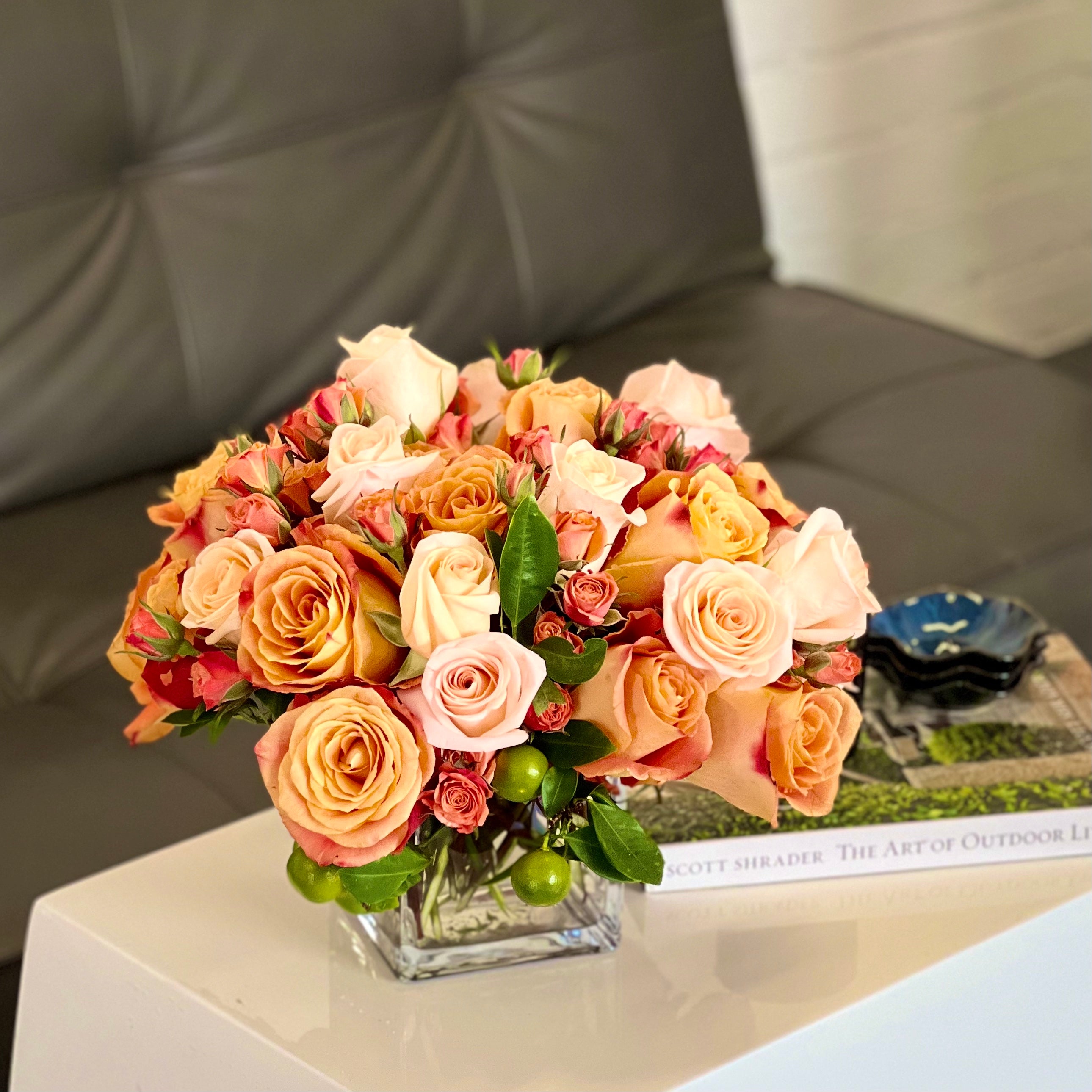 Blooms of Sunshine - Elegant Citrus Delight arrangement featuring vibrant flowers in a handcrafted 11-inch round design, perfect for brightening any space.