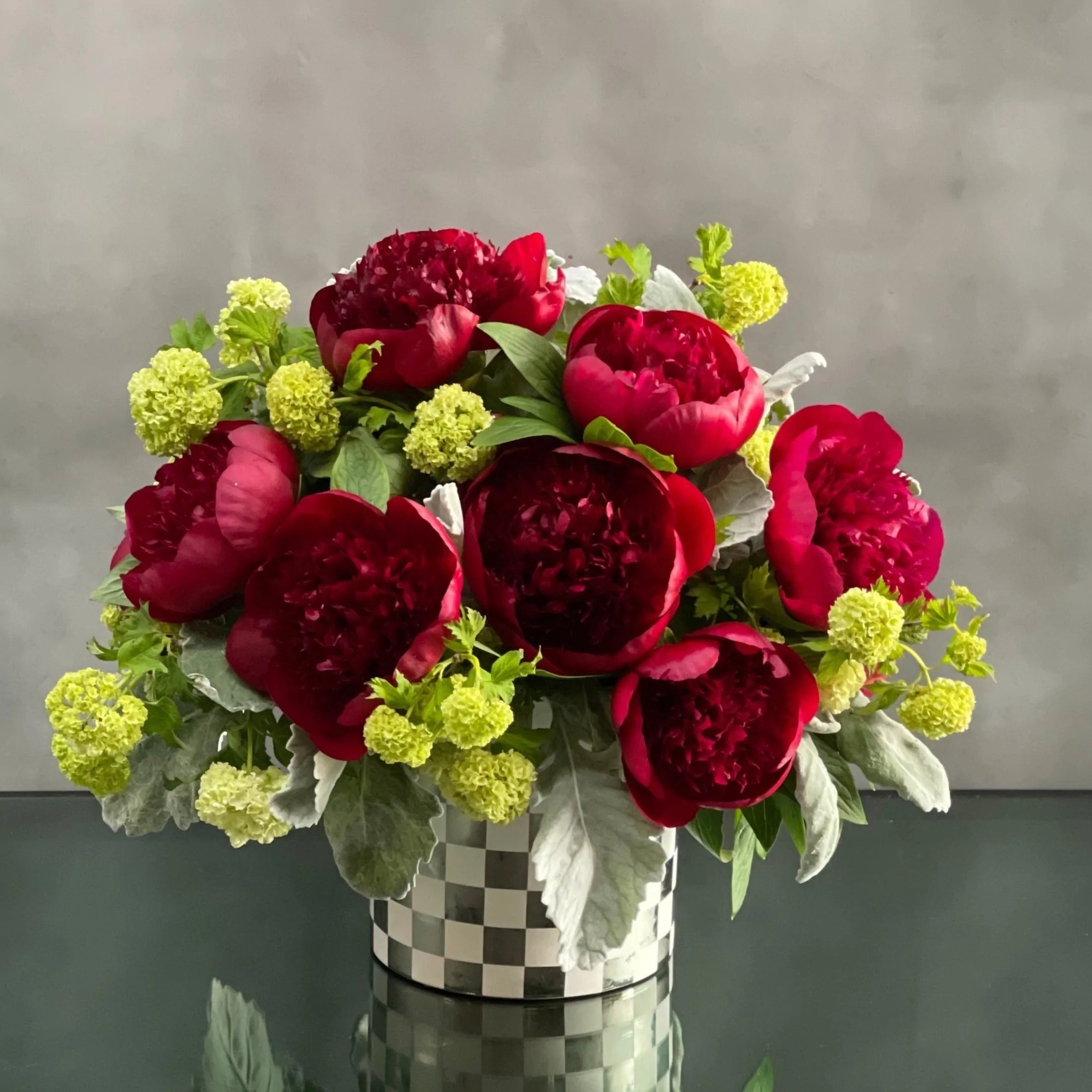 IMG_0023-1 This arrangement our team has created is available for same day delivery ! This floral piece from Beverly Hills Florist includes rich burgundy Peonies with green accents in a shiny checkered vase. Beautifully made for love and romance, birthday, i'm sorry or anniversary.