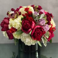 Beverly Hills Florist presents an arrangement that is sure to wow and its available for same day delivery! Our floral piece includes peonies, lavender and white and red roses, cymbidium orchids , nested on hydrangeas in a black cylinder vase. A stunning decoration for any home or office! Or a romantic gesture of love !