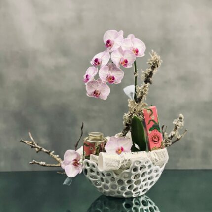 Beverly Hills Florist presents delightful pink Orchids and embellished butterfly on branches that grace this design held in a modern ceramic container. Rose hand cream, 3 bar soaps, and bottle of bath salt included in this beautiful arrangement. This is the perfect I love you ! Beautifully pieced together for Love and romance, thank you and congratulations !