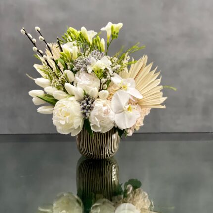 This arrangement is made with a designer's choice array of seasonal white flowers. Floral could include Roses, Hydrangeas, Orchids, Tulips and or Peonies. These beautiful white flowers are an excellent choice for weddings, funerals and other major life events. Our team at Beverly Hills Florist offers same day delivery!
