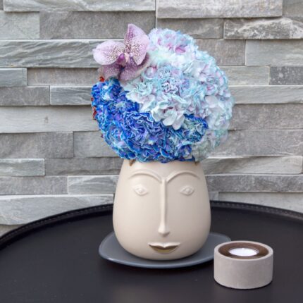 My Beverly Hills florist presents our floral arrangement available for same day delivery. Dyed florals, shades of blue with an Orchid and seasonal blooms placed in a facial ceramic vase