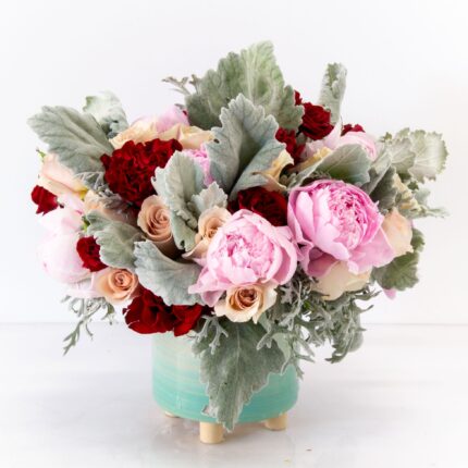 My Beverly Hills florist presents a vibrant and eye catching design that will light up any space with 1 Dozen of pink Peonies, accented with sand color and burgundy Heart Roses, create a lovely accent amongst the delicate shades of pink and approximately 18" tall and 18" wide with a beautiful ceramic container. Our Pink and Red Paradise is now available for same day delivery !