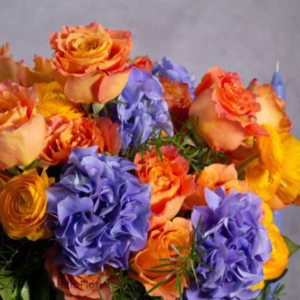The Tale of Orange Roses and Blue Hydrangeas Arrangement
Luxury Orange Garden Roses and Blue Hydrangeas in White Vase
Sunburst Floral Arrangement for Same-Day Delivery Beverly Hills
Vibrant Orange and Blue Floral Arrangement Los Angeles Delivery