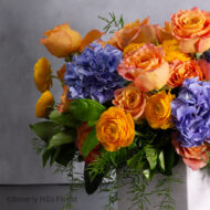 The Tale of Orange Roses and Blue Hydrangeas Arrangement
Luxury Orange Garden Roses and Blue Hydrangeas in White Vase
Sunburst Floral Arrangement for Same-Day Delivery Beverly Hills
Vibrant Orange and Blue Floral Arrangement Los Angeles Delivery