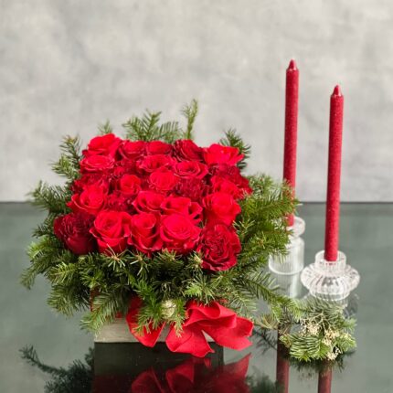 A Merry Little Christmas centerpiece with red roses, greenery, and gold ornaments, available for same-day delivery by Beverly Hills Florist.