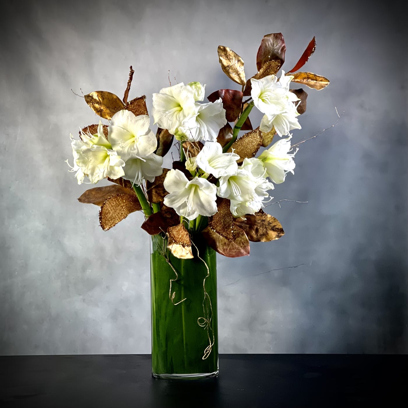 a-modern-christmas-amaryllis-holiday-centerpiece-bh-florist.j A Modern Christmas arrangement featuring amaryllises in a sleek 36-inch vase, perfect for holiday decor, available for same-day delivery by Beverly Hills Florist.