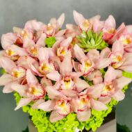 A Pink Delicate Touch arrangement with pink cymbidium orchids, hydrangeas, and succulent in a heart-shaped box, modern same-day delivery by Beverly Hills Florist.