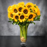 Baby It's Sunny Outside arrangement with tall sunflowers in a vase with pebbles, available for same-day delivery by Beverly Hills Florist.