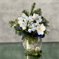 Blue Holiday arrangement with snow-tinted tulips and an orchid in a glass vase, available for same-day delivery by Beverly Hills Florist.