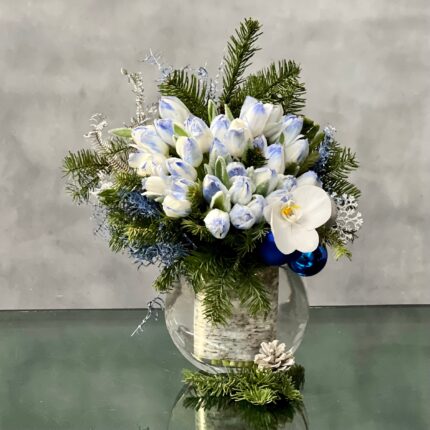 Blue Holiday arrangement with snow-tinted tulips and an orchid in a glass vase, available for same-day delivery by Beverly Hills Florist.