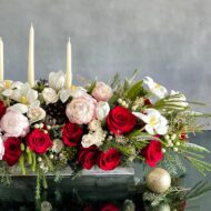 Elegant holiday centerpiece featuring red roses, white tulips, peonies, and berries in a chic arrangement for same-day delivery in Beverly Hills, CA.