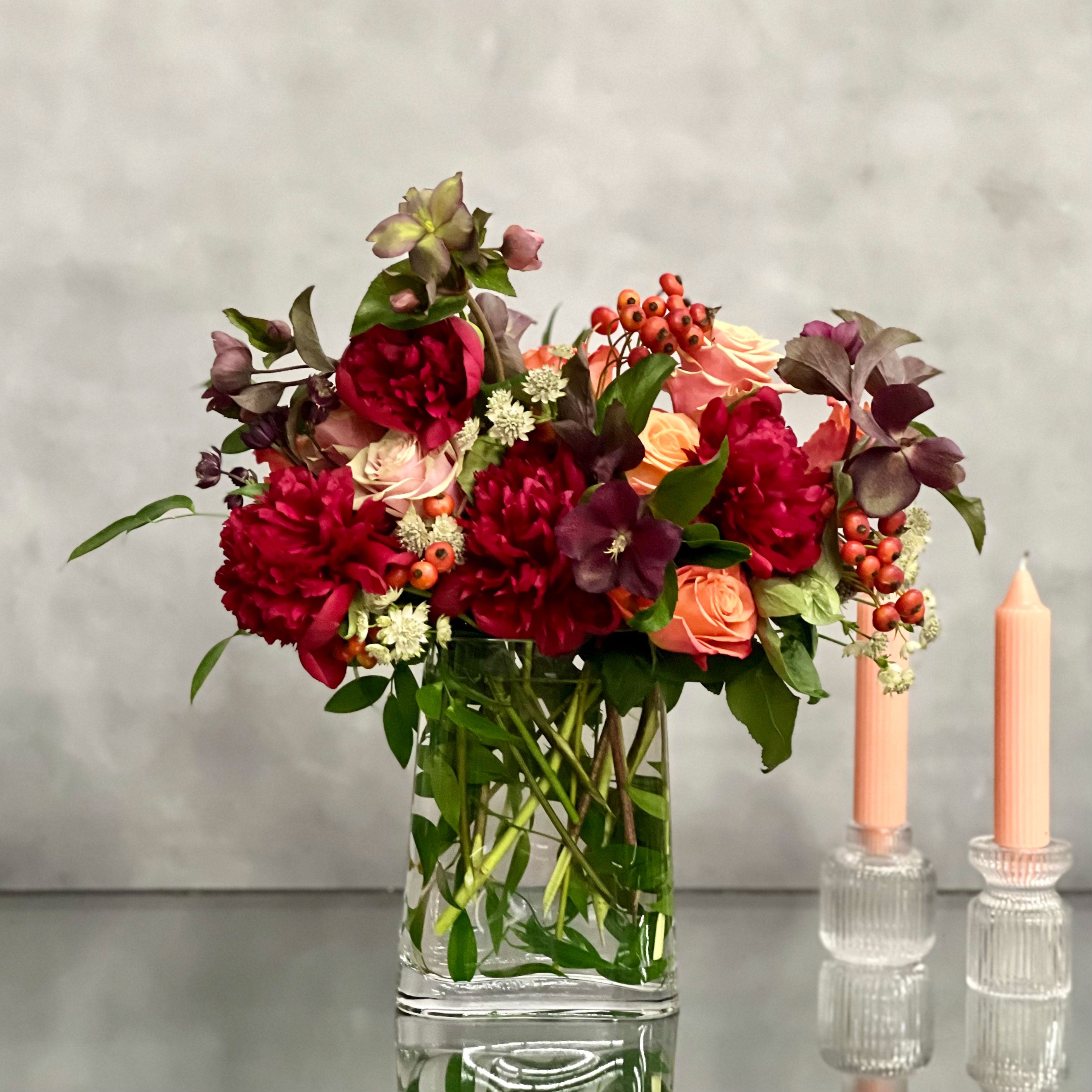 majestic-winter-orange-roses-burgundy-peonies-glass-vase-beverly-hills-florist Majestic winter arrangement with orange roses, burgundy peonies, and winter accents in a glass vase – available for same-day delivery by Beverly Hills Florist.