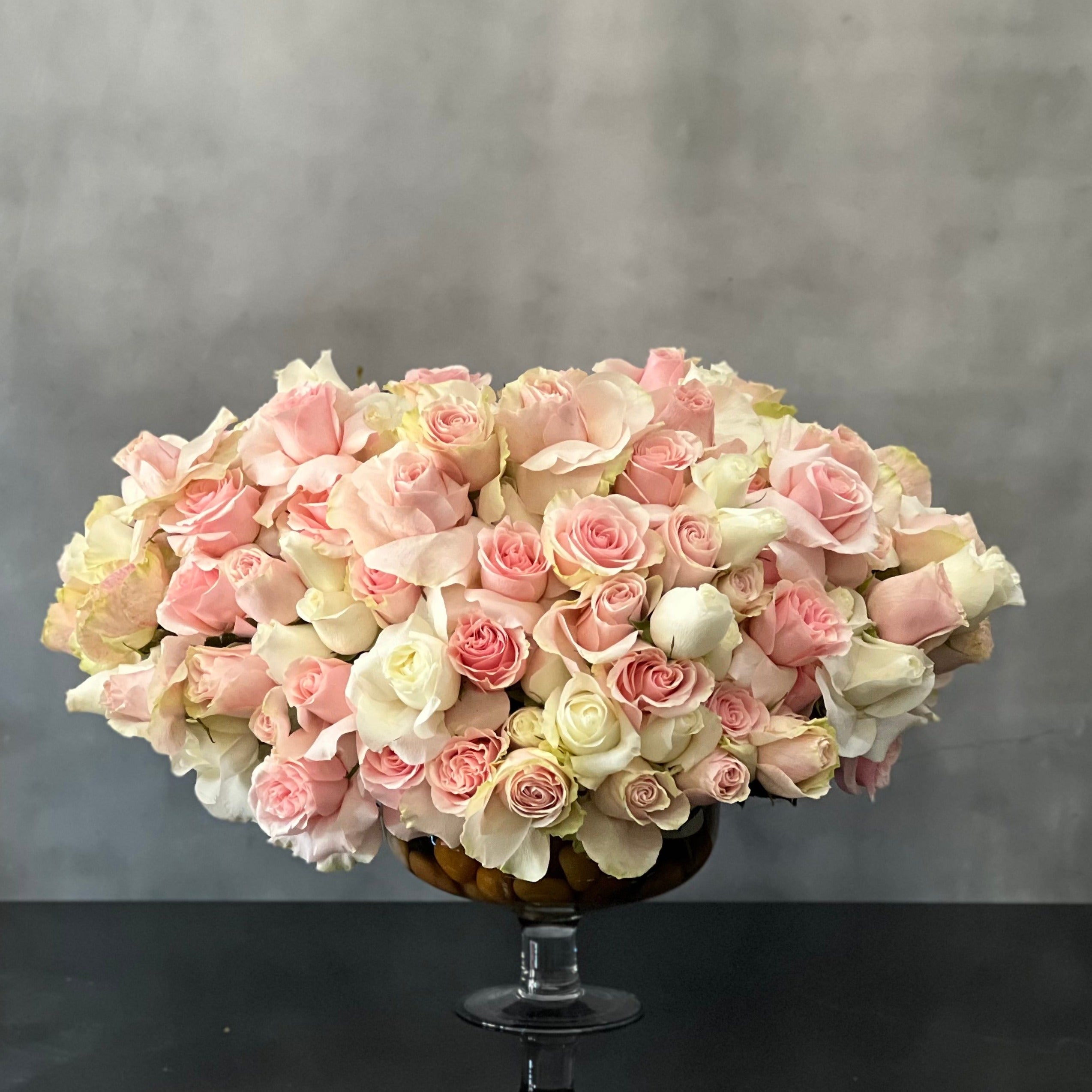 passion_in_pink Designed to be the ultimate expression of your affection our team at Beverly Hills Florist can arrange our Passion in Pink for same day delivery. In our floral piece we have over 100 stems of Light Pink and white South American Roses are exquisitely arranged in a container. This is sure to leave an impression that's impossible to forget! A notion of sincerity making it wonderful for love and romance, thinking of you, congratulations, welcomes and more !