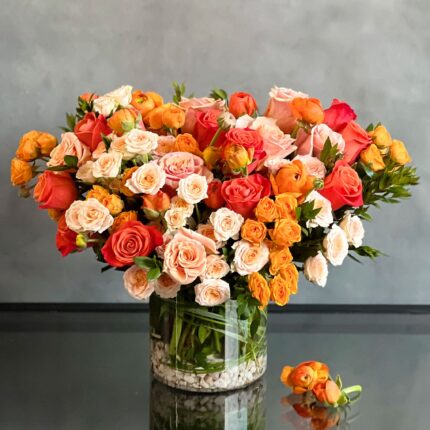 Peachy Sunset Floral Arrangement with Orange Roses and Peach Spray Roses
Elegant Ranunculus and Rose Arrangement in Glass Vase
Luxury Floral Arrangement for Same-Day Delivery Beverly Hills
Peachy Sunset Flower Arrangement for Los Angeles Delivery