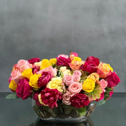 Beverly Hills Florist has True Colors available for same day delivery. This arrangement of colorful roses in an oval glass vase is a wonderful gift, sure to brighten day and lift spirits.. Includes, Hot Pink Roses, Yellow Roses, Pink Roses, Baby Peonies and other various greens. Perfect for Birthday flowers, Congratulation Flowers, Welcome homes and more !