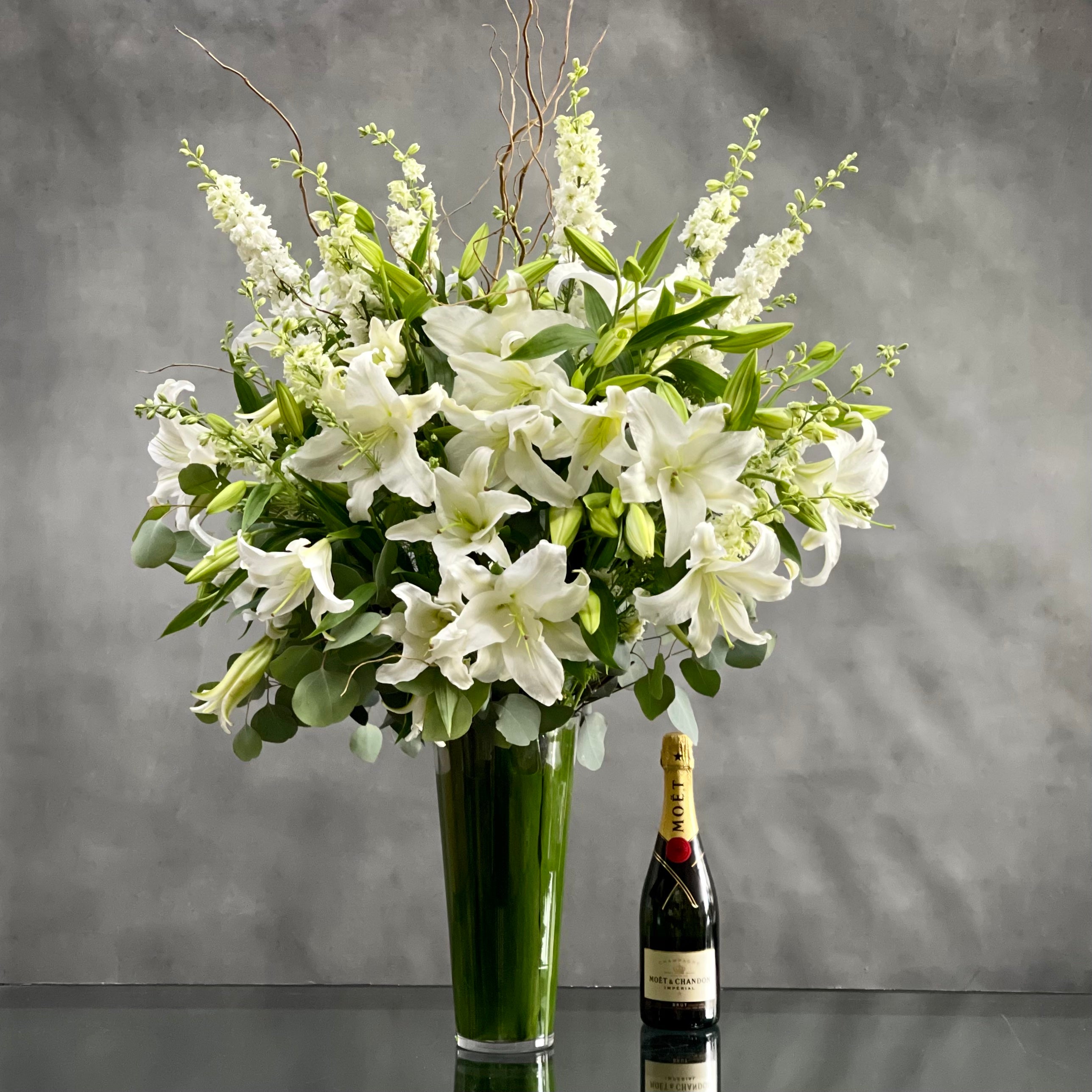 white_lily_lilies This Display of over 20 Stems of Crystal White Lily's accented with locally Grown Flowers and Greens is available for same day Delivery at Beverly Hills Florist. This Bouquet is placed in a leaf lined 14" Tall vase with an opening of 5" and it is Approx. 45" Tall and 32 Wide. Birthday Flowers, Just because flowers, thinking of you flowers